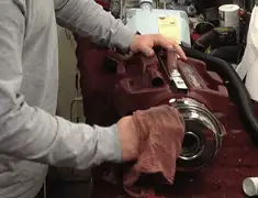 Vacuum repair technician cleaning and servicing a vacuum motor in Cedar Rapids, IA